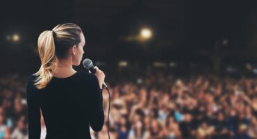 Donna con microfono su palco pubblico